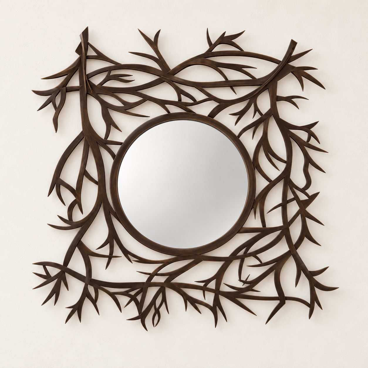 Branches Wall Mirror with a round centre and dark brown branching metal frame on a warm-white wall.