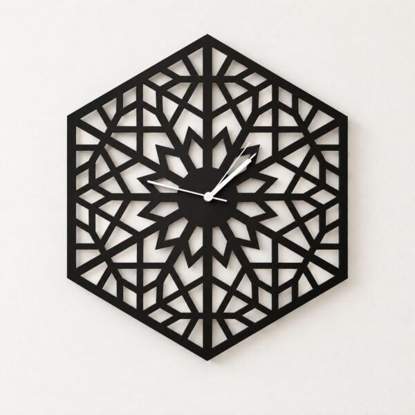 Black metal Hexa Wall Clock with geometric cut-outs on a plain warm-white wall.