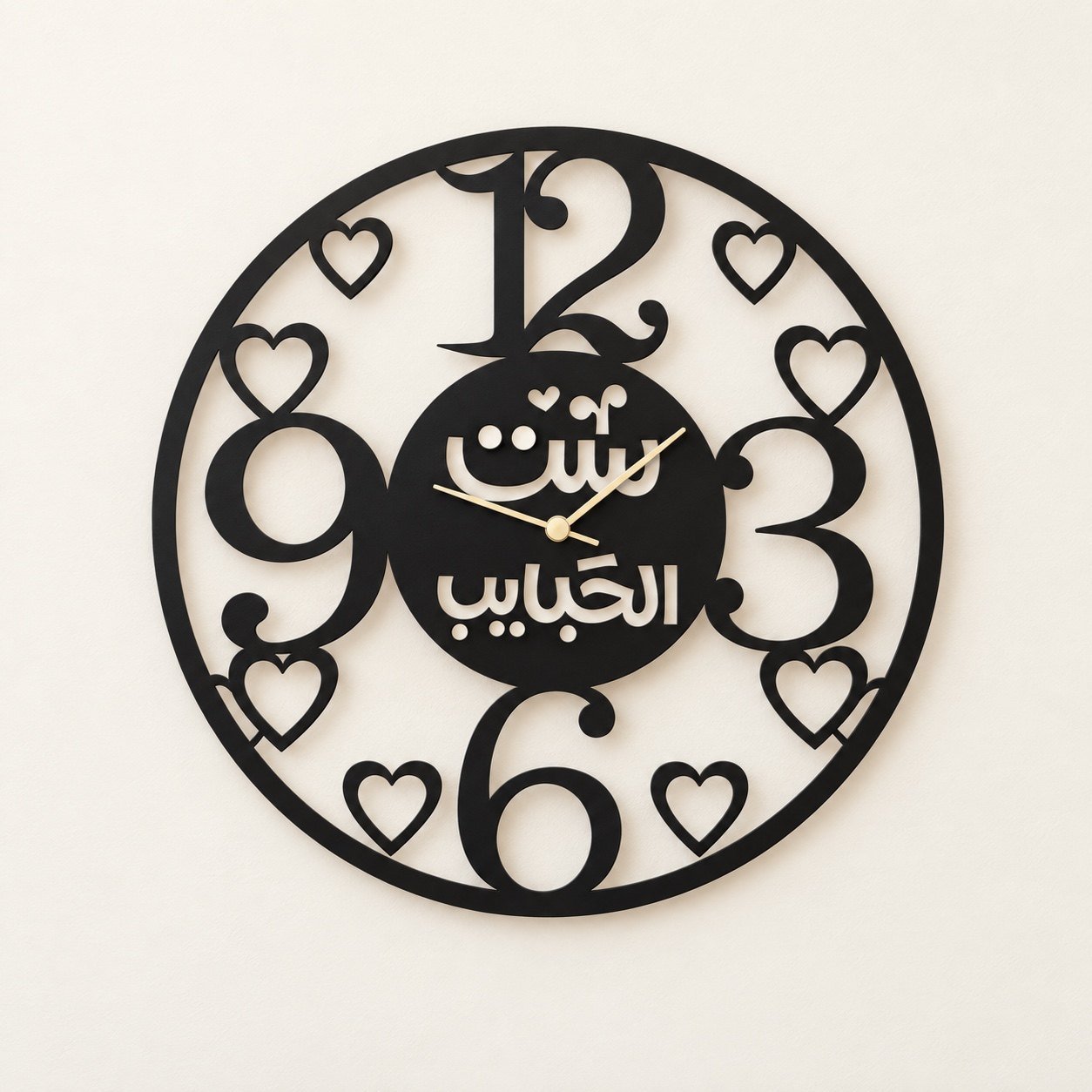 Front view of the black circular Mothers Day Arabic calligraphy wall clock on a warm-white wall.