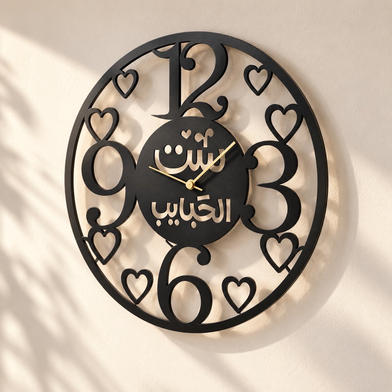Angled view of the black metal wall clock showing its raised depth, edge finish, and soft wall shadow.