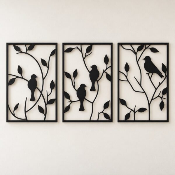 Three-piece black metal birds and branches wall art set on a warm-white wall