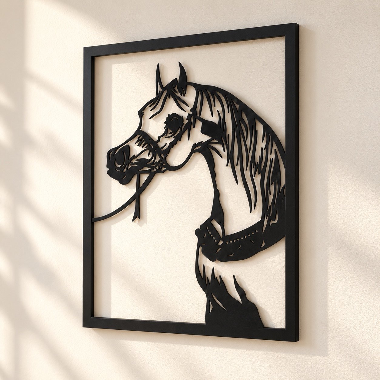 Angled view of black metal horse wall art showing its cut-out depth, edge finish and wall shadow.