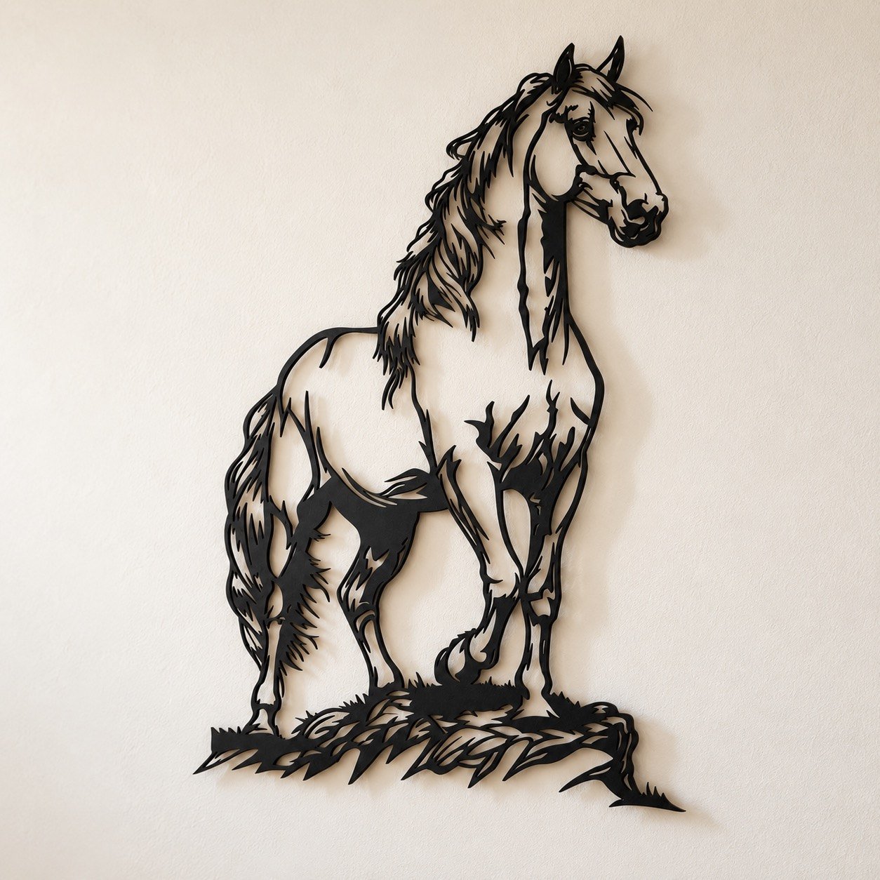Slightly angled view of complete black metal horse wall art showing edge depth and soft wall shadow.
